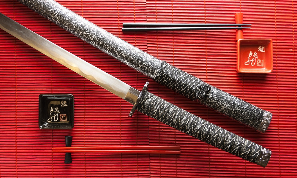 Traditional Japanese katana sword on red bamboo mat - 1000 years of sword-making history