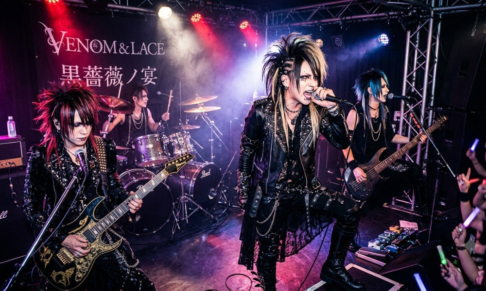 Visual kei band performing live in a small Tokyo venue with teased hair, dark stage makeup, studded leather and chains under red and purple lights