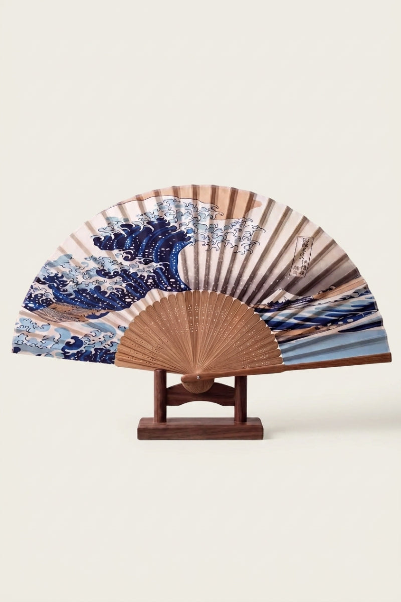 Japanese fan collection: folding sensu fan on a wooden stand, printed with Hokusai's Great Wave off Kanagawa in indigo and cream