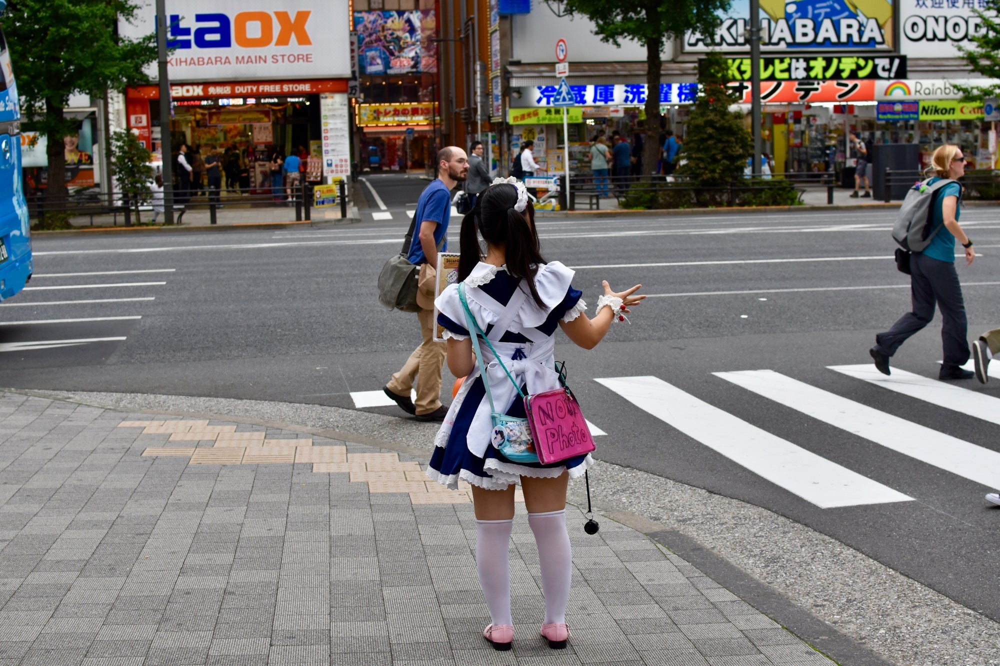 Street view of Akihabara in Tokyo filled with neon lights and anime culture, representing modern Japan’s pop energy in the Japan Clothing Lookbook.