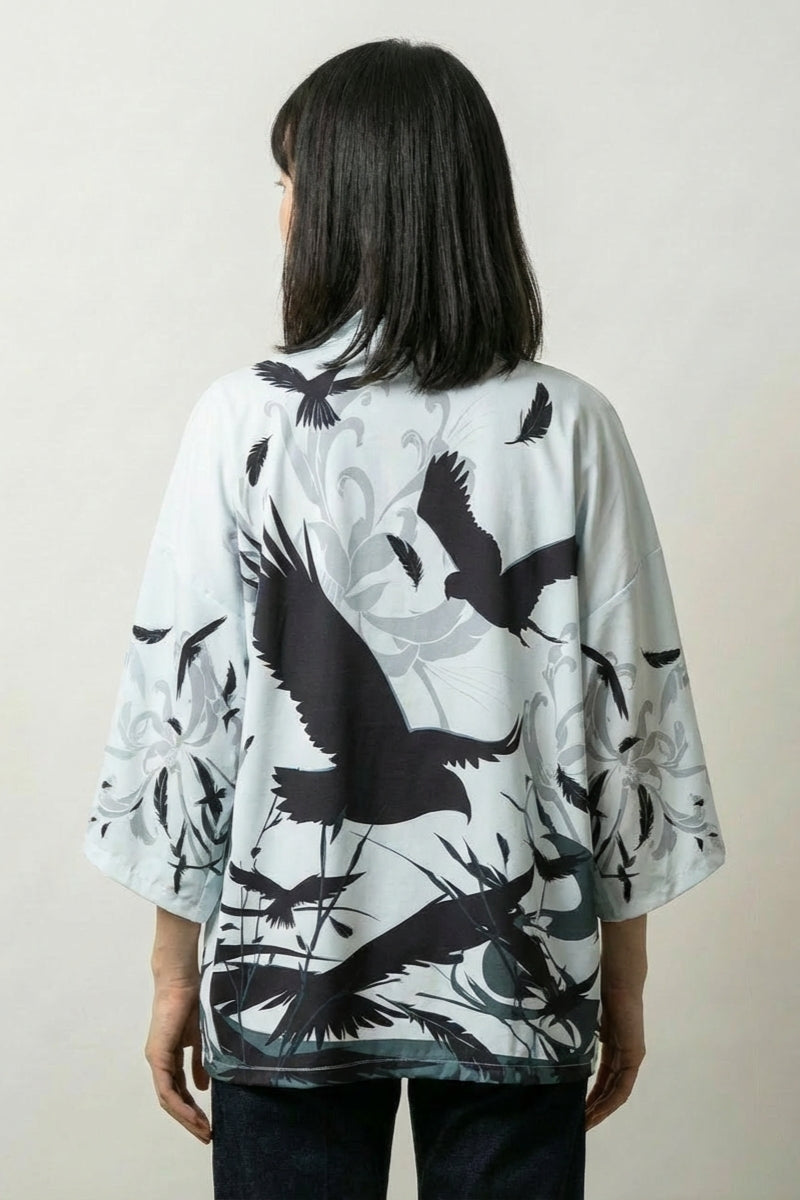 Back view of the Hisae kimono jacket: black cranes rising through tall reeds and grasses drawn like a sumi-e brush painting on cream