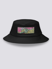 Black bucket hat with an embroidered patch of a small vintage green and yellow train crossing cherry blossom and yellow flower fields