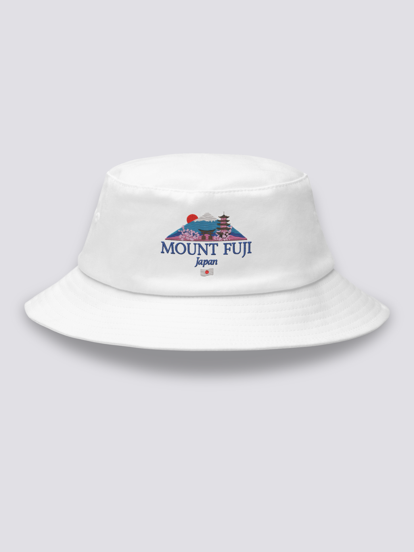 Khaki bucket hat with an embroidered Mount Fuji scene framed by a torii, a pagoda, a red sun and cherry blossom above MOUNT FUJI lettering