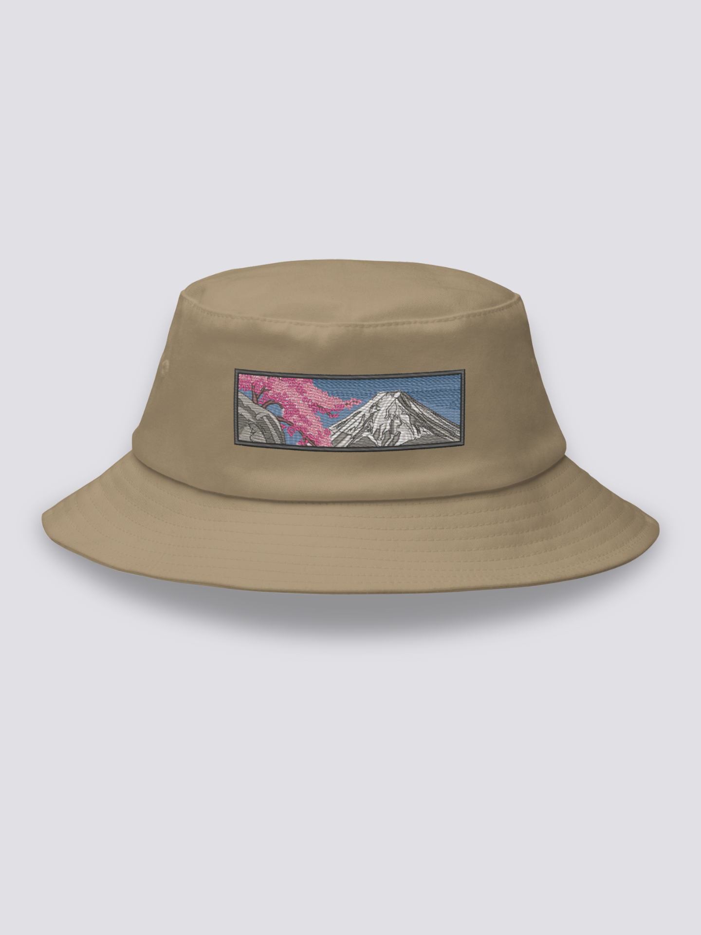 Grey bucket hat with an embroidered sumi-e patch of Mount Fuji in white and grey with a cherry branch over a slate sky