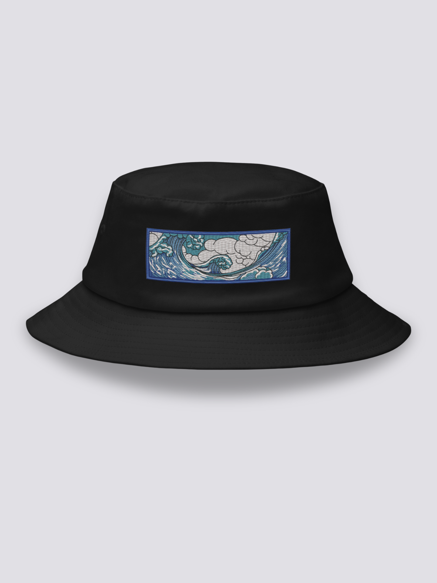 Black bucket hat with an embroidered horizontal patch of the Great Wave in clawed white foam over blue and turquoise water