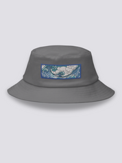 Grey bucket hat with an embroidered horizontal patch of the Great Wave in clawed white foam over blue and turquoise water