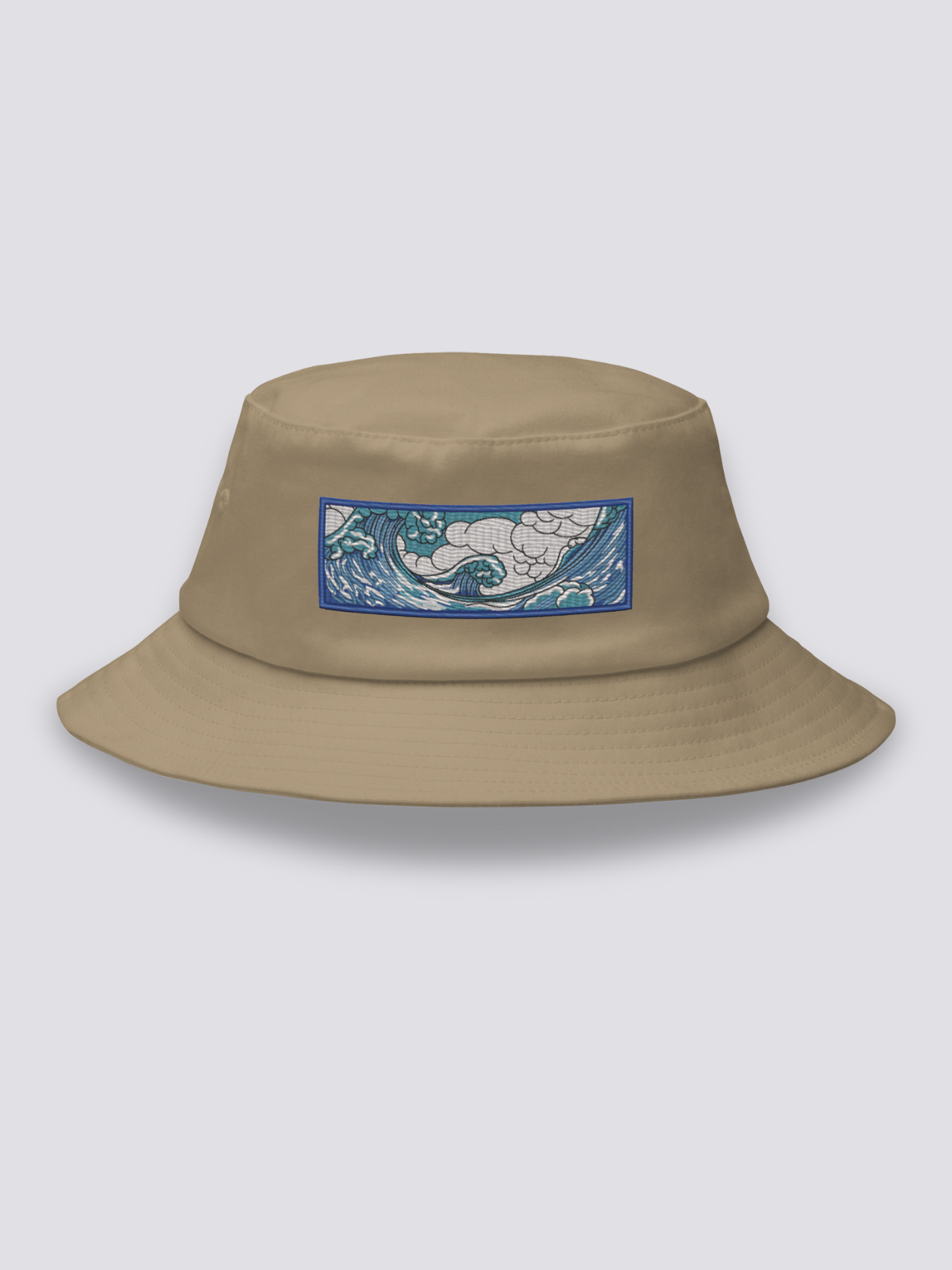 Khaki bucket hat with an embroidered horizontal patch of the Great Wave in clawed white foam over blue and turquoise water