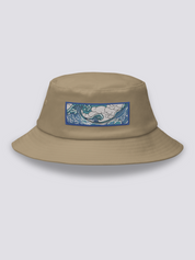 Khaki bucket hat with an embroidered horizontal patch of the Great Wave in clawed white foam over blue and turquoise water