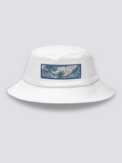 White bucket hat with an embroidered horizontal patch of the Great Wave in clawed white foam over blue and turquoise water