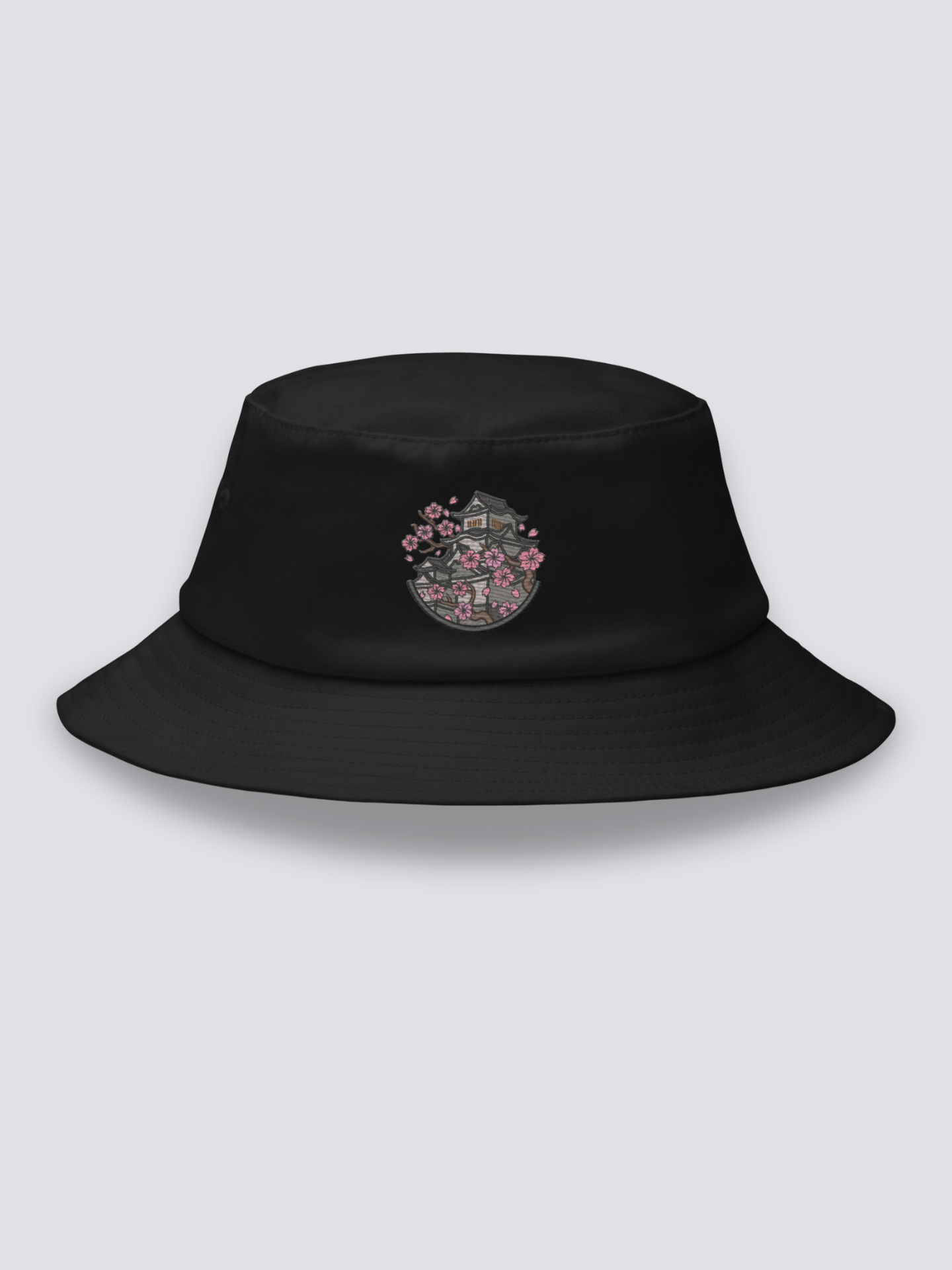 Black bucket hat with an embroidered medallion of Himeji Castle framed by pink cherry blossom branches
