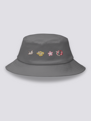 Grey bucket hat with four embroidered icons in a row: an origami crane, geta sandals, a cherry blossom and a red koi carp