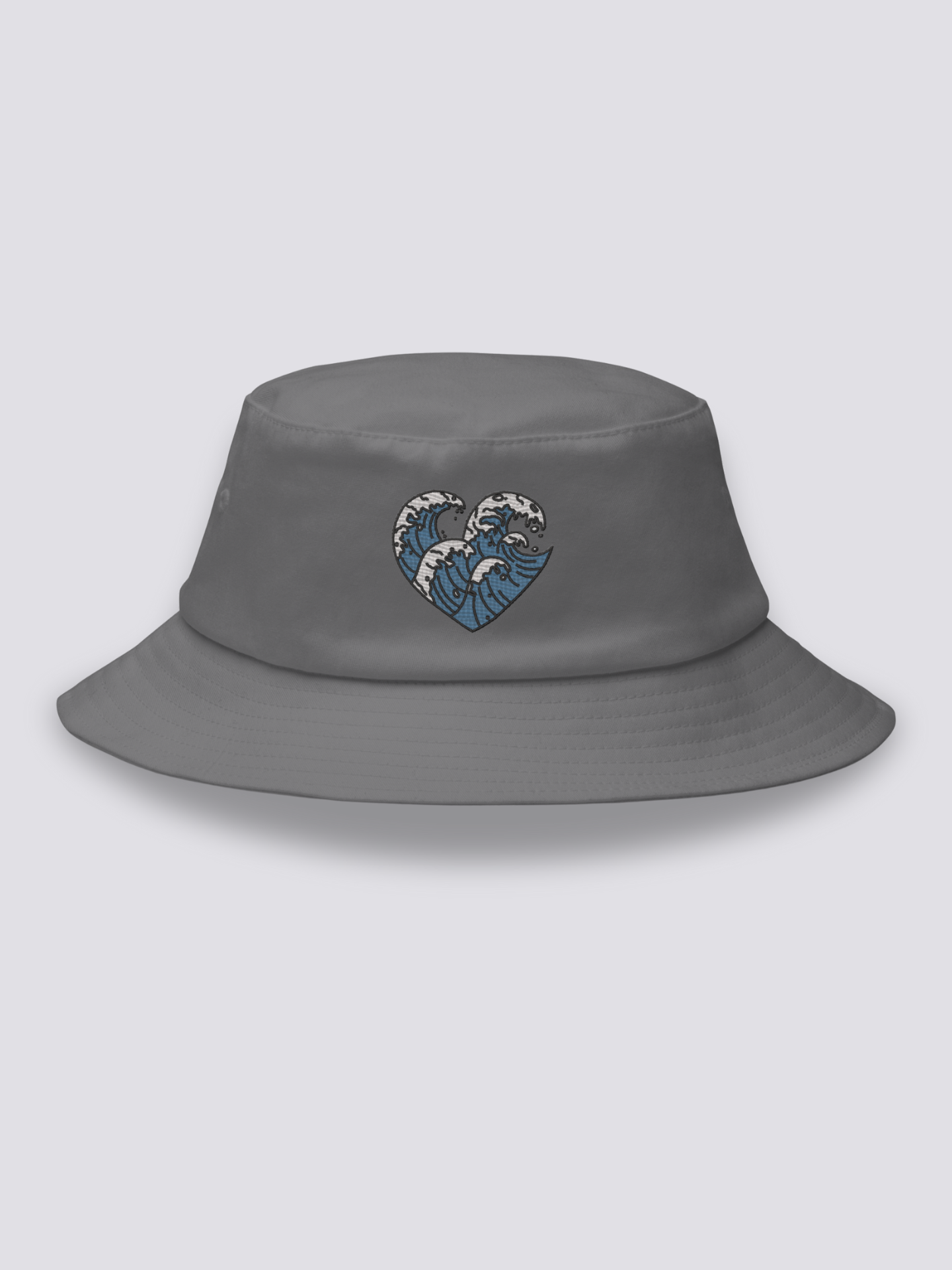 White bucket hat with three embroidered ukiyo-e waves arranged into a heart shape in blue and white