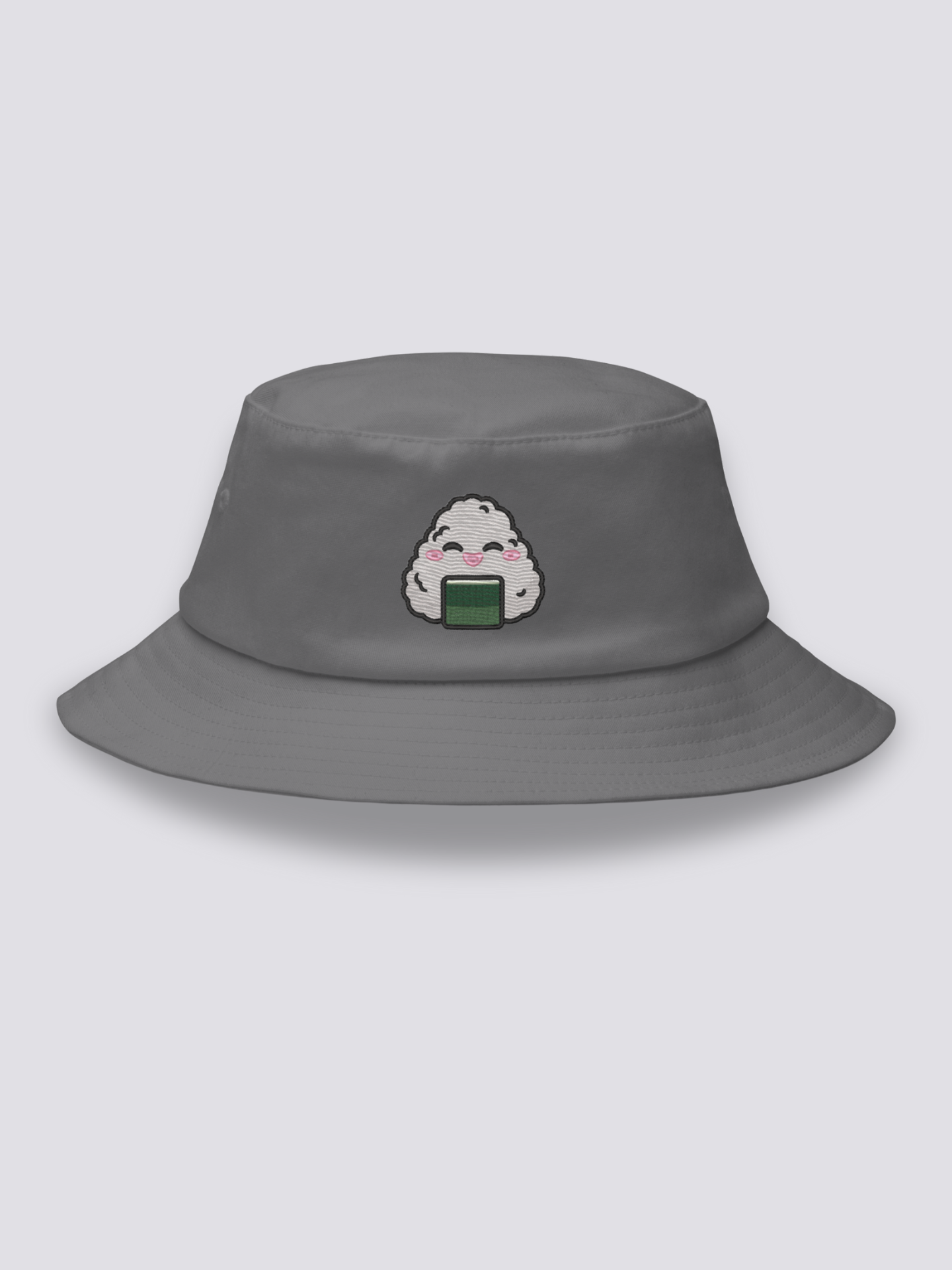 White bucket hat with an embroidered smiling kawaii onigiri rice ball with closed eyes, pink cheeks and a band of nori