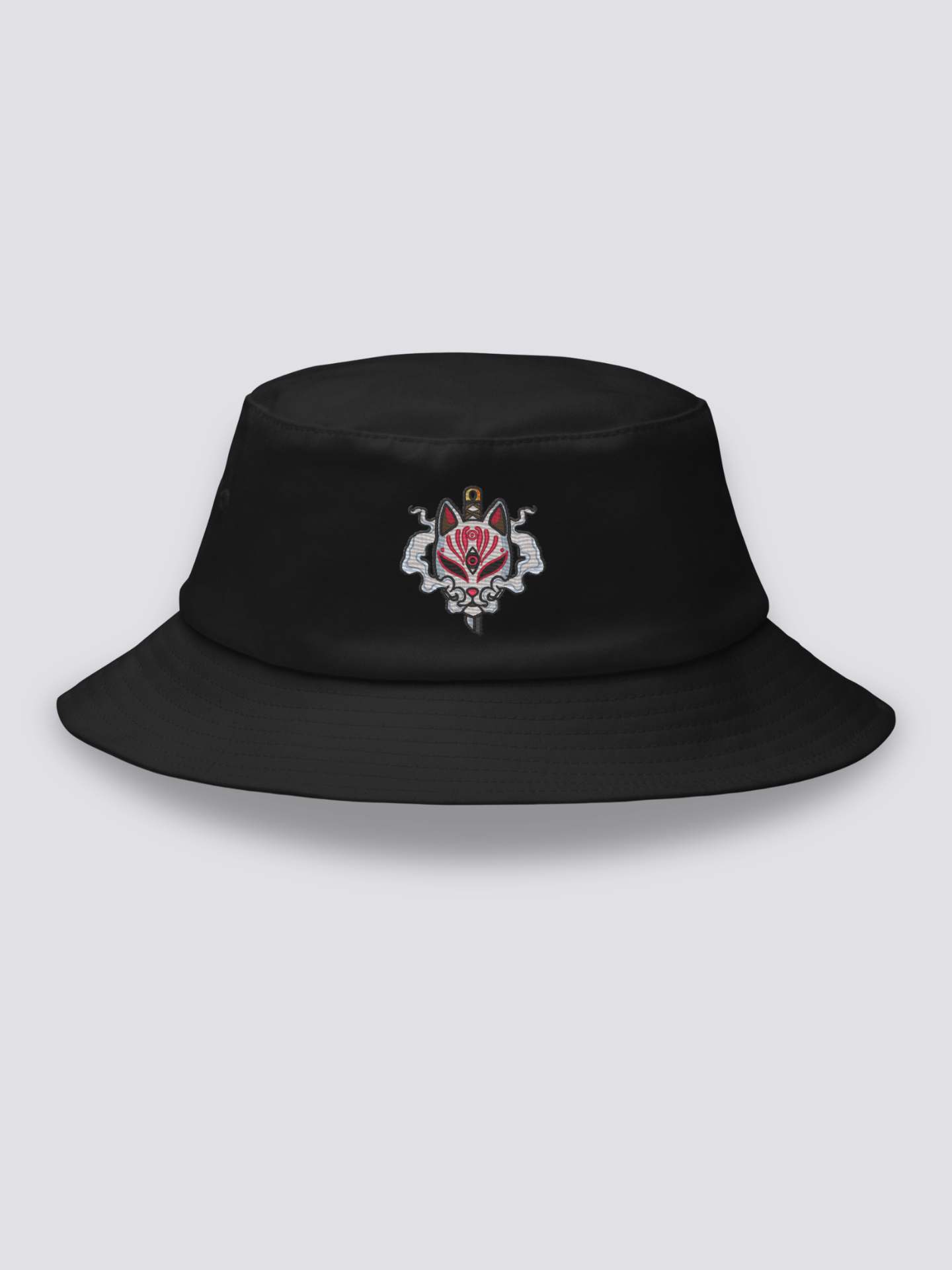 Black bucket hat with an embroidered white fox mask pierced vertically by a black katana blade, stylized smoke on both sides