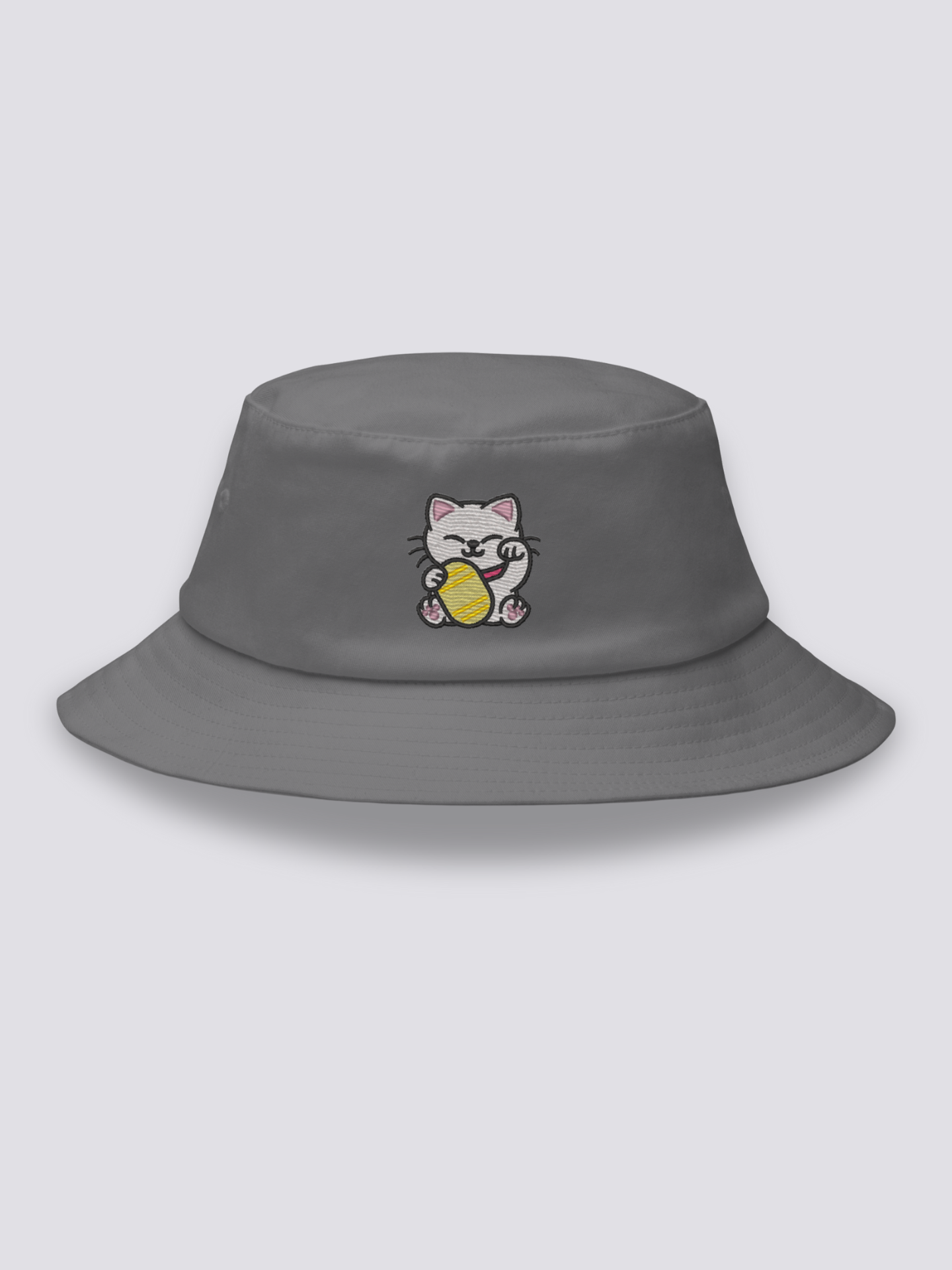 White bucket hat with an embroidered smiling maneki neko beckoning cat holding a gold koban coin