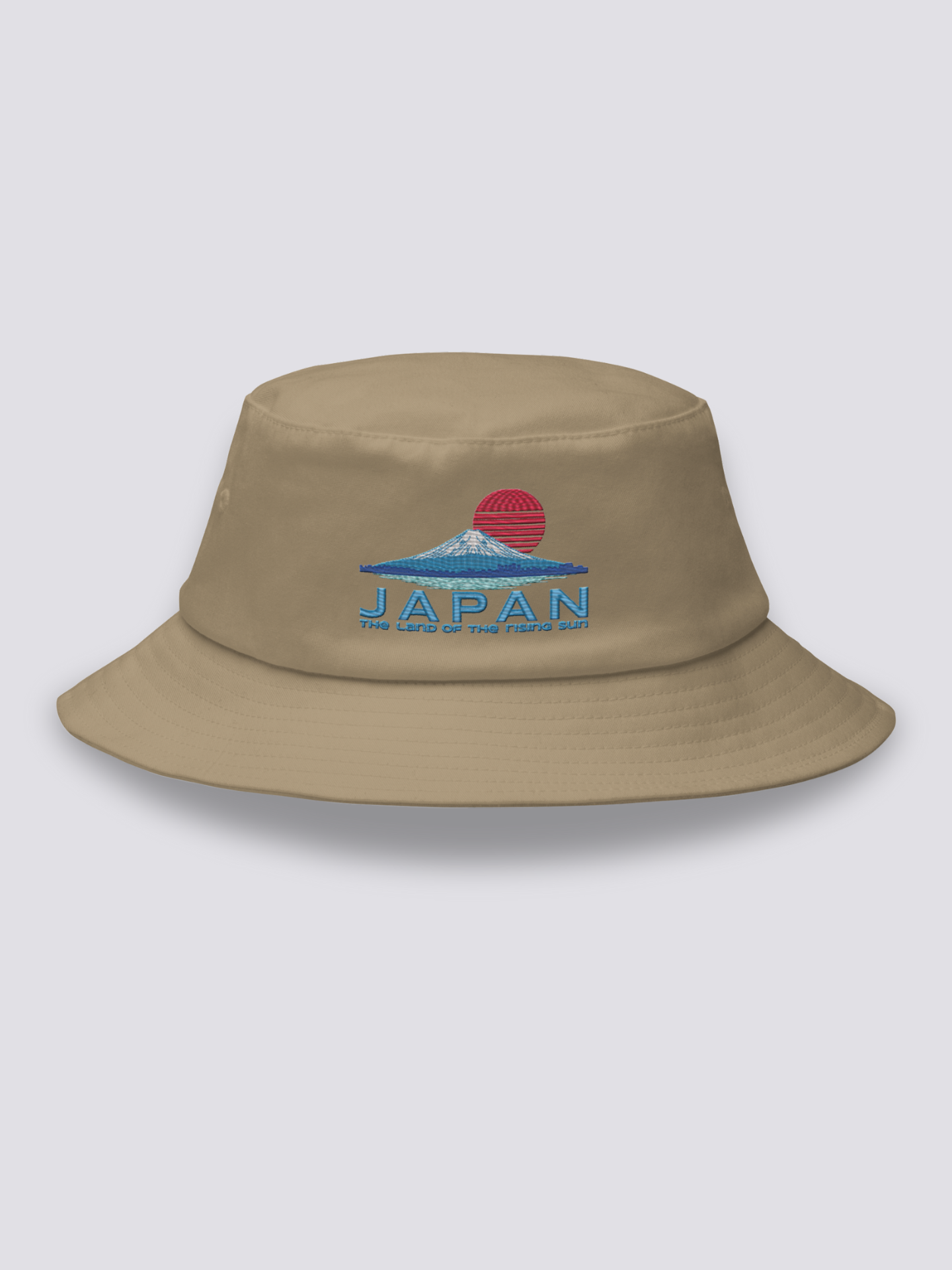 Khaki bucket hat with an embroidered striped red sun above a deep blue Mount Fuji and JAPAN lettering in navy