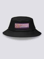 Black bucket hat with an embroidered patch of a warbler on a cherry branch before Mount Fuji at dusk