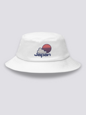 Khaki bucket hat with an embroidered red striped sun behind a white cloud above JAPAN in navy lettering