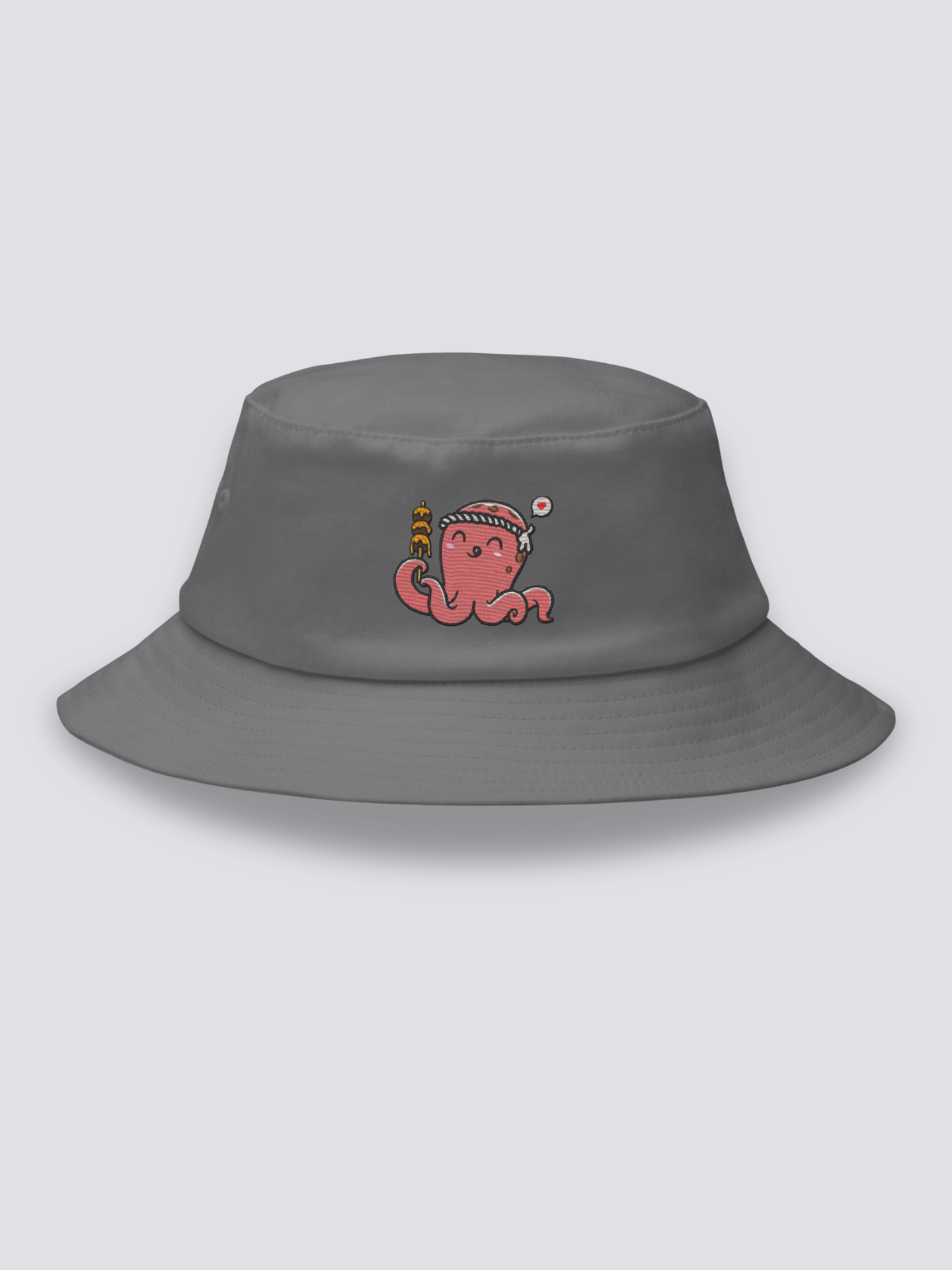 Grey bucket hat with an embroidered smiling coral-pink octopus wearing a hachimaki headband and holding a takoyaki skewer