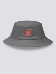 Grey bucket hat with an embroidered smiling coral-pink octopus wearing a hachimaki headband and holding a takoyaki skewer