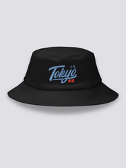 Black bucket hat with Tokyo embroidered in thick blue vintage cursive script above the red kanji 東京