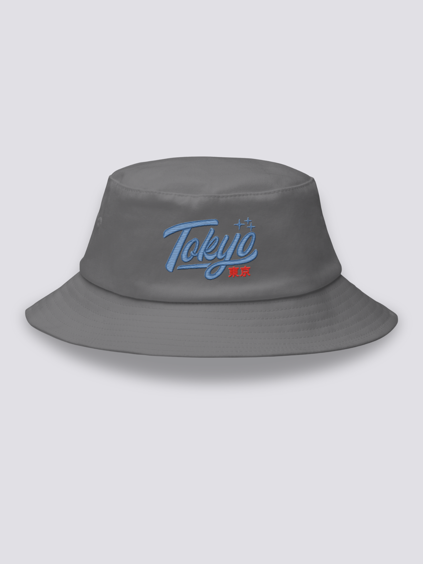 Grey bucket hat with Tokyo embroidered in thick blue vintage cursive script above the red kanji 東京
