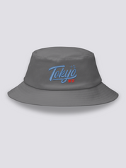 Grey bucket hat with Tokyo embroidered in thick blue vintage cursive script above the red kanji 東京