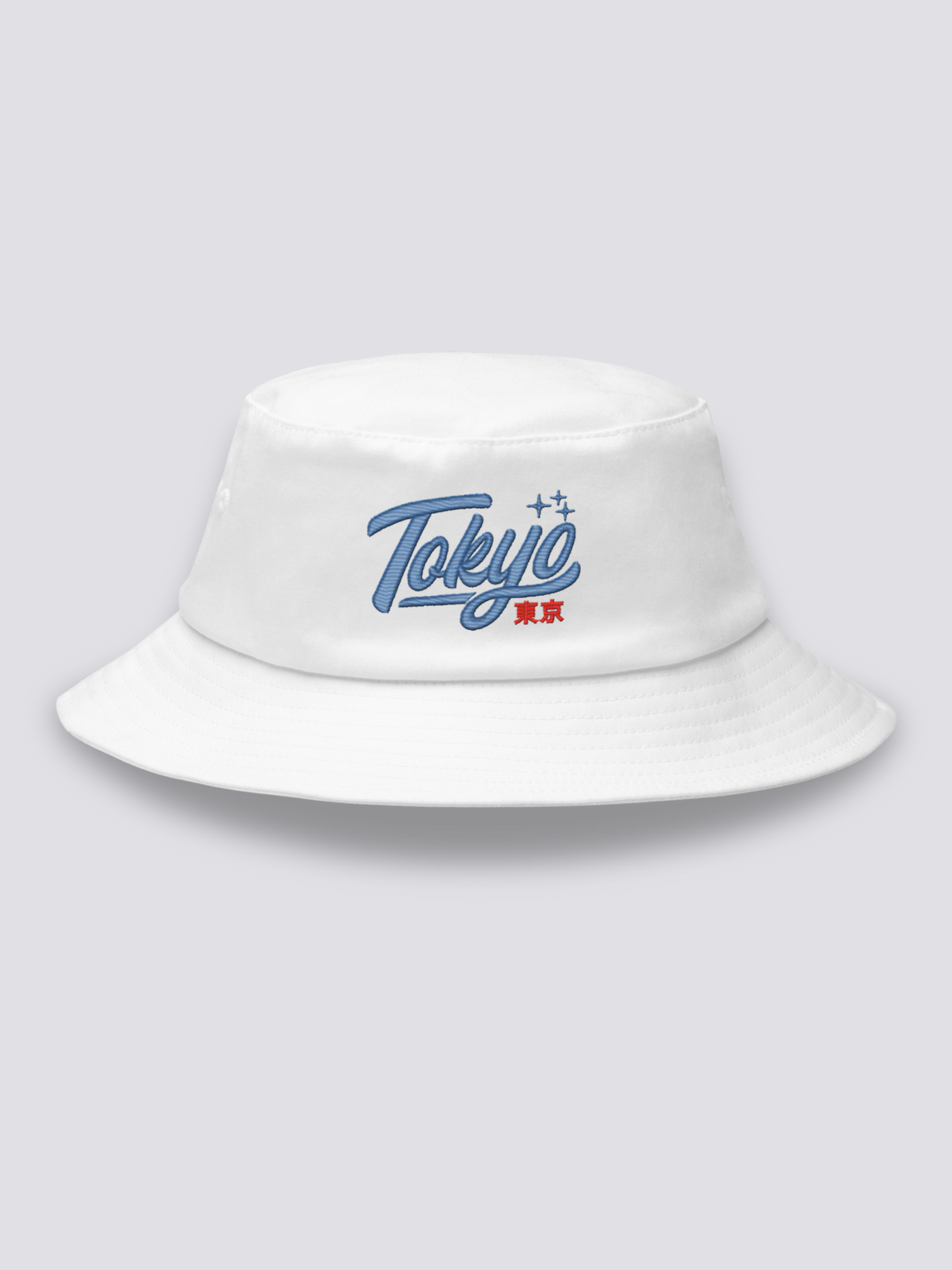 White bucket hat with Tokyo embroidered in thick blue vintage cursive script above the red kanji 東京