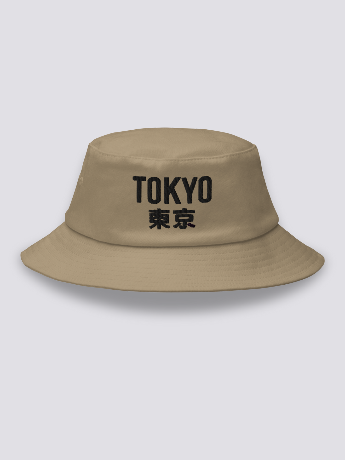 Khaki bucket hat with TOKYO embroidered in heavy black sans-serif capitals followed by the kanji 東京