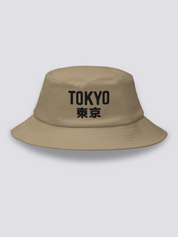 Khaki bucket hat with TOKYO embroidered in heavy black sans-serif capitals followed by the kanji 東京