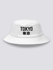White bucket hat with TOKYO embroidered in heavy black sans-serif capitals followed by the kanji 東京