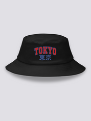 Black bucket hat with TOKYO embroidered in arched red varsity capitals above the navy kanji 東京