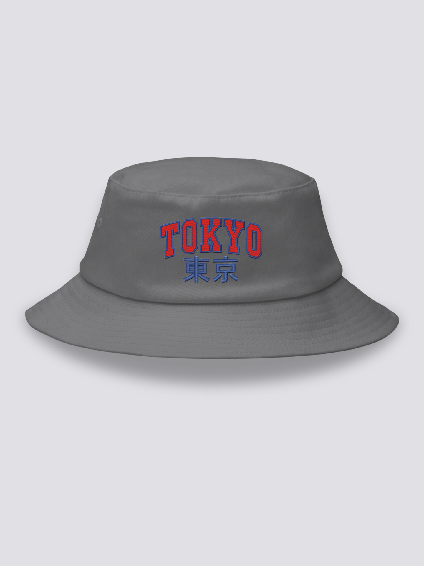 Grey bucket hat with TOKYO embroidered in arched red varsity capitals above the navy kanji 東京