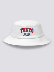White bucket hat with TOKYO embroidered in arched red varsity capitals above the navy kanji 東京