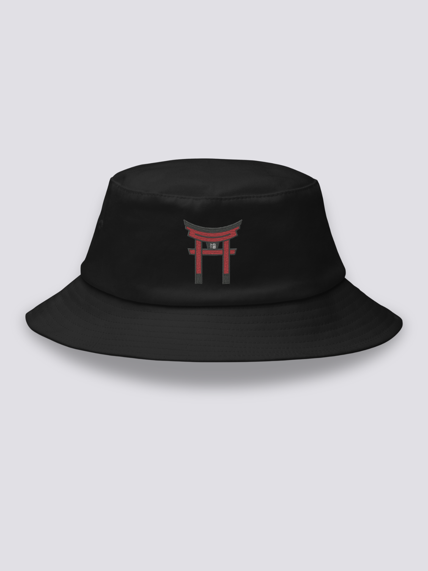 Black bucket hat with a single vermilion torii gate embroidered in a minimal architectural study
