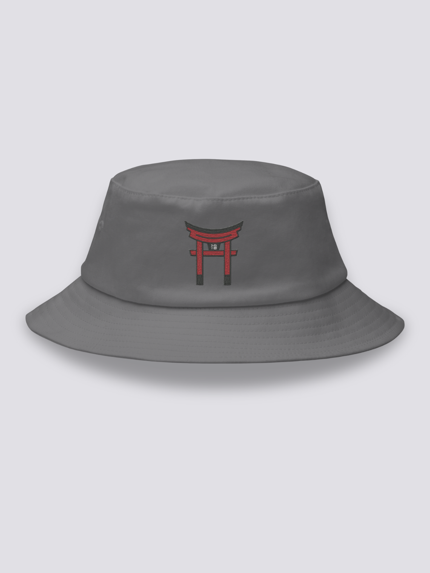 White bucket hat with a single vermilion torii gate embroidered in a minimal architectural study
