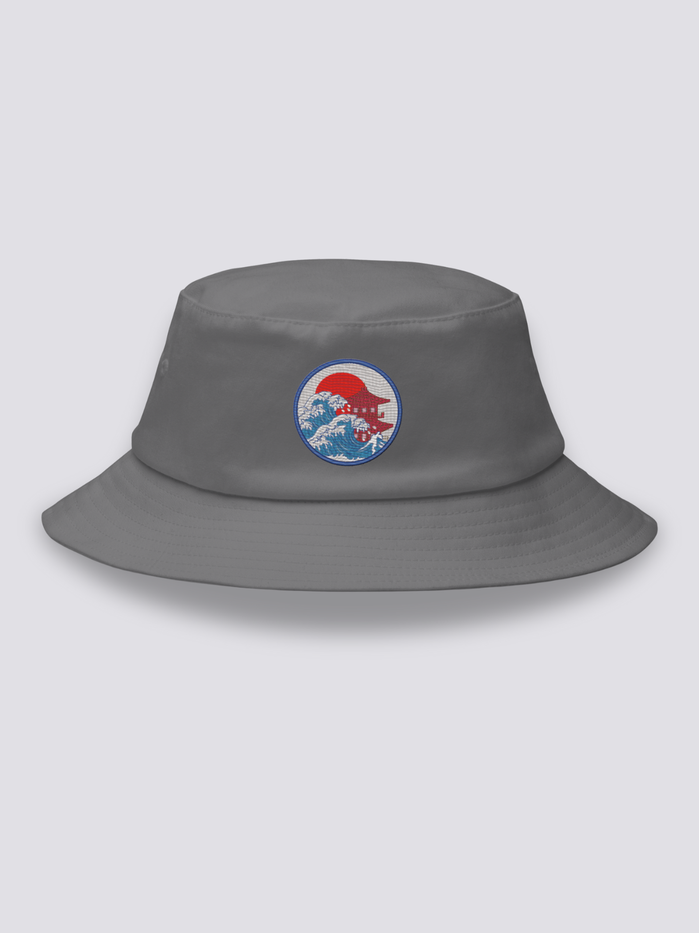 Grey bucket hat with an embroidered blue medallion combining ukiyo-e waves, a red tiered pagoda and a red sun