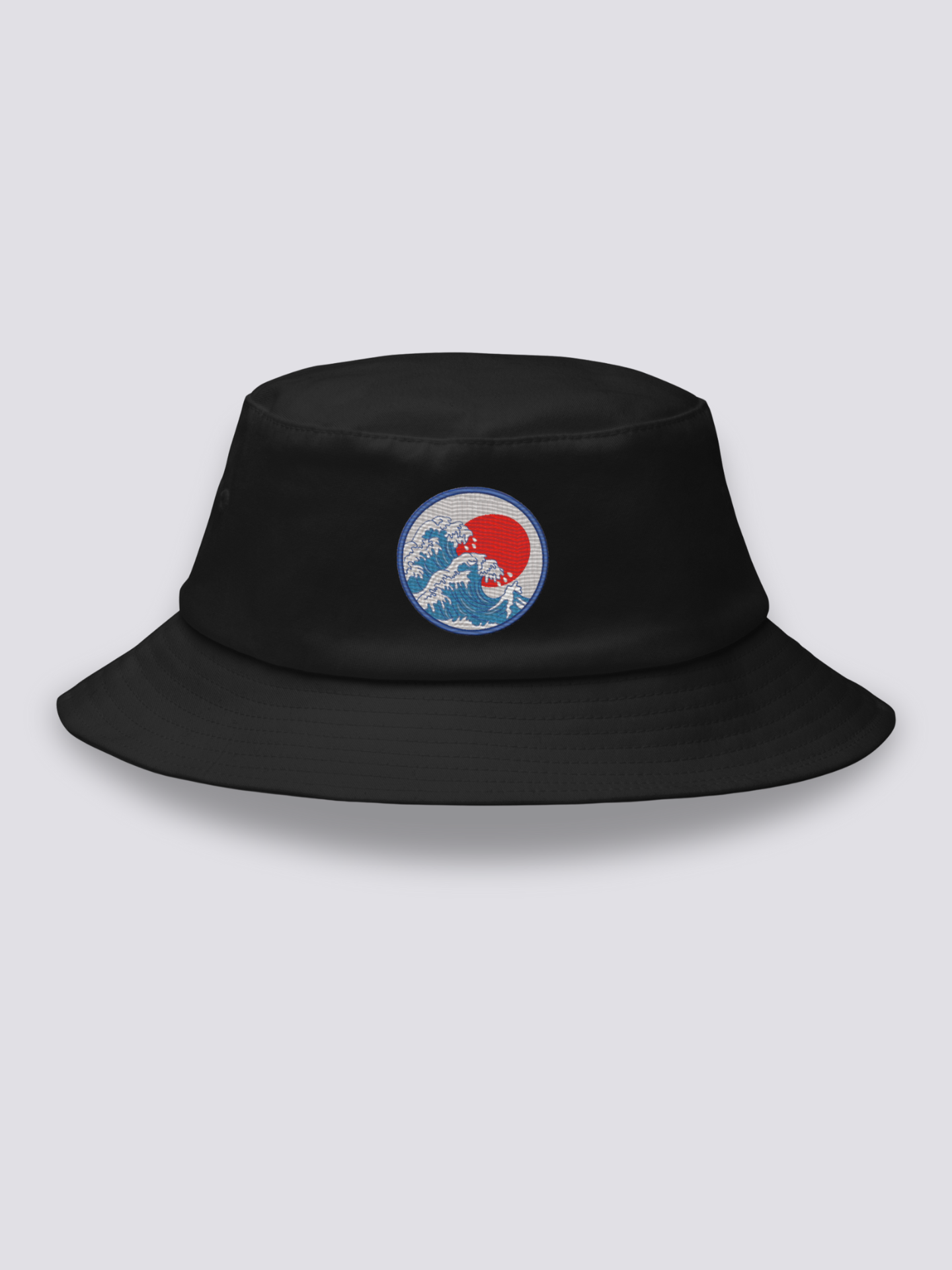 Black bucket hat with an embroidered blue medallion of the Great Wave breaking beneath a full red sun