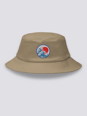 Grey bucket hat with an embroidered blue medallion of the Great Wave breaking beneath a full red sun