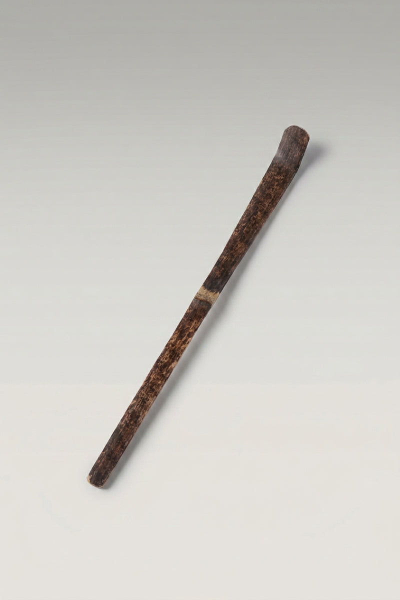 Chashaku bamboo matcha scoop in dark brown smoked bamboo, hand-cut with a curved tip and mottled grain