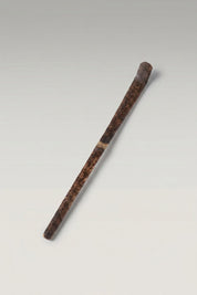 Chashaku bamboo matcha scoop in dark brown smoked bamboo, hand-cut with a curved tip and mottled grain