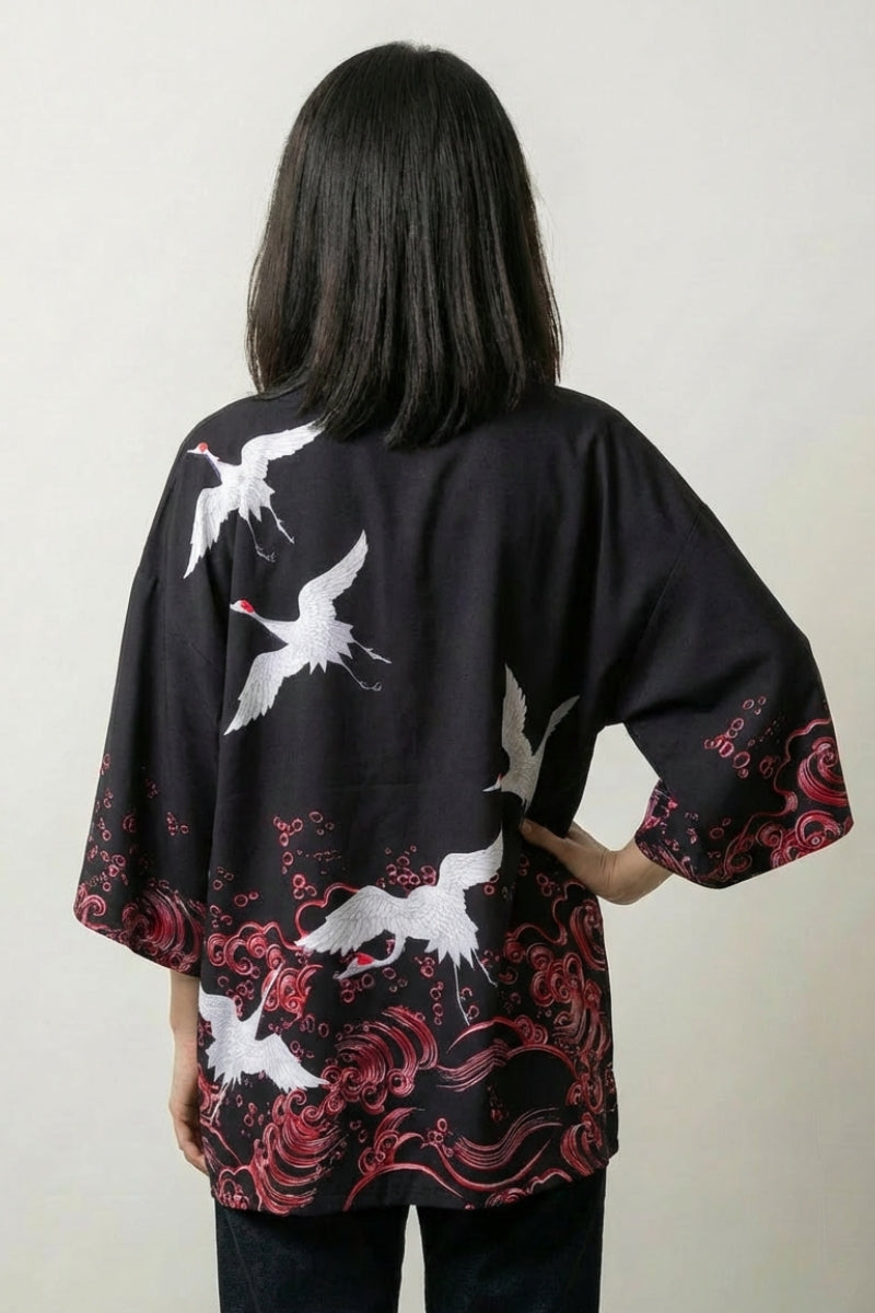 Back view of the Mayumi crane kimono: a red-crowned white crane rising over crimson peonies and breaking waves on black