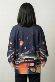 Back view of the Shizuka furisode kimono: a riverside temple at dusk with paper lanterns drifting into a deep blue sky and a torii in the distance