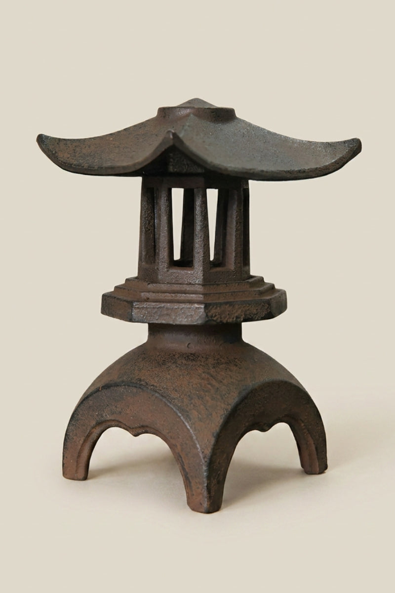 Japanese cast-iron lantern — Japanese stone garden lantern, a dark cast-iron garden lantern with a curved pagoda roof, traditional toro