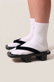 Japanese Geta 'Hekinan' — all-black wooden platform sandals with plain black hanao straps, minimalist traditional geta worn with white socks