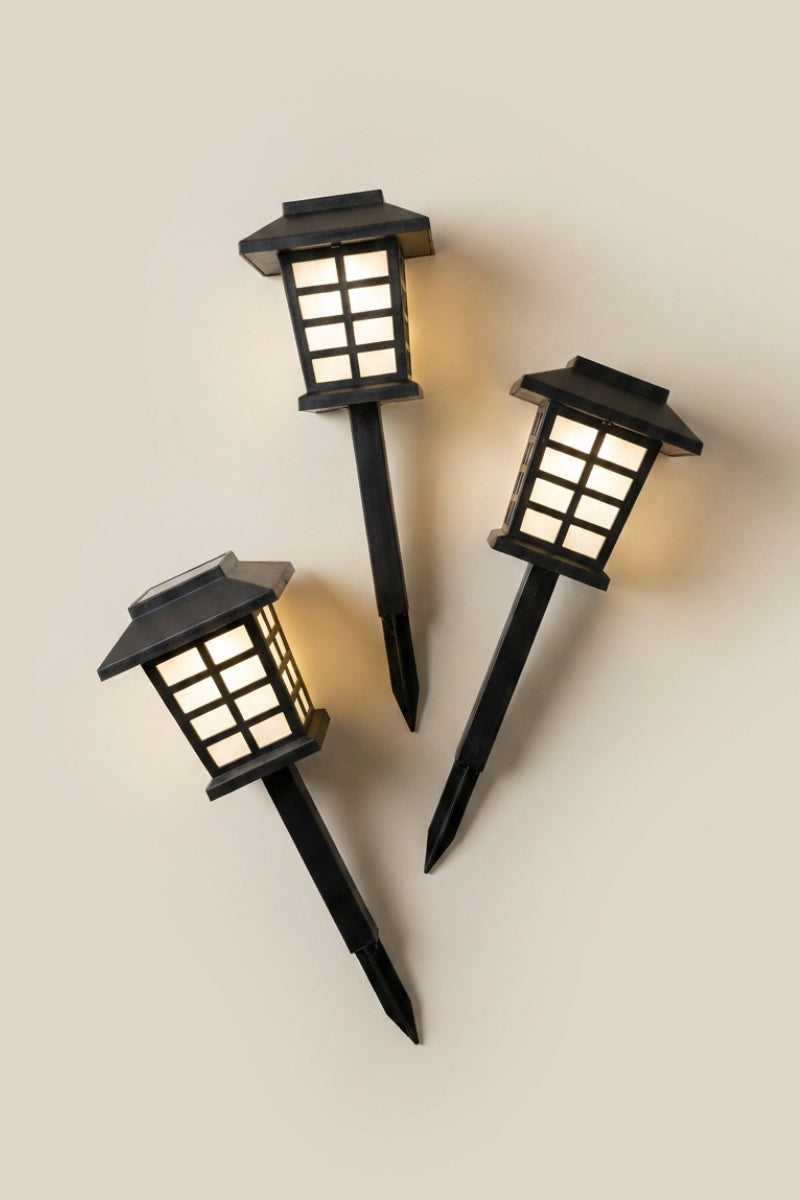 Japanese LED lantern — Japanese solar garden lantern, a set of three black solar LED garden stake lanterns with warm glowing panels
