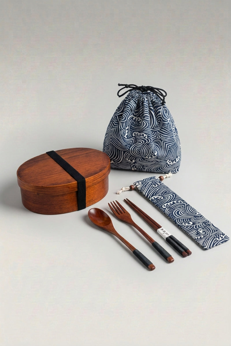 Japanese wooden bento box with elastic band, indigo wave-print drawstring bag and a wooden spoon, fork and chopstick set in a matching pouch