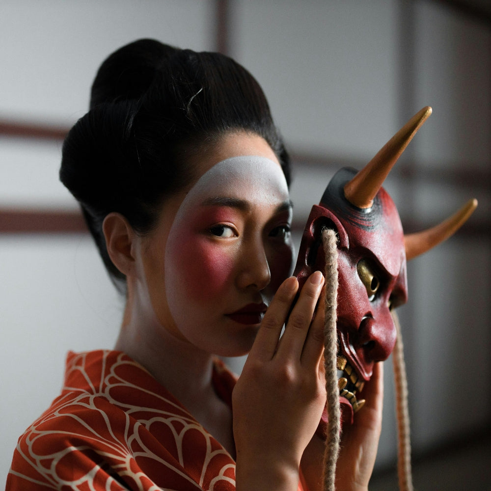 Woman wearing traditional Japanese kimono holding a red Hannya mask — Japanese accessories collection by Japanstreet.