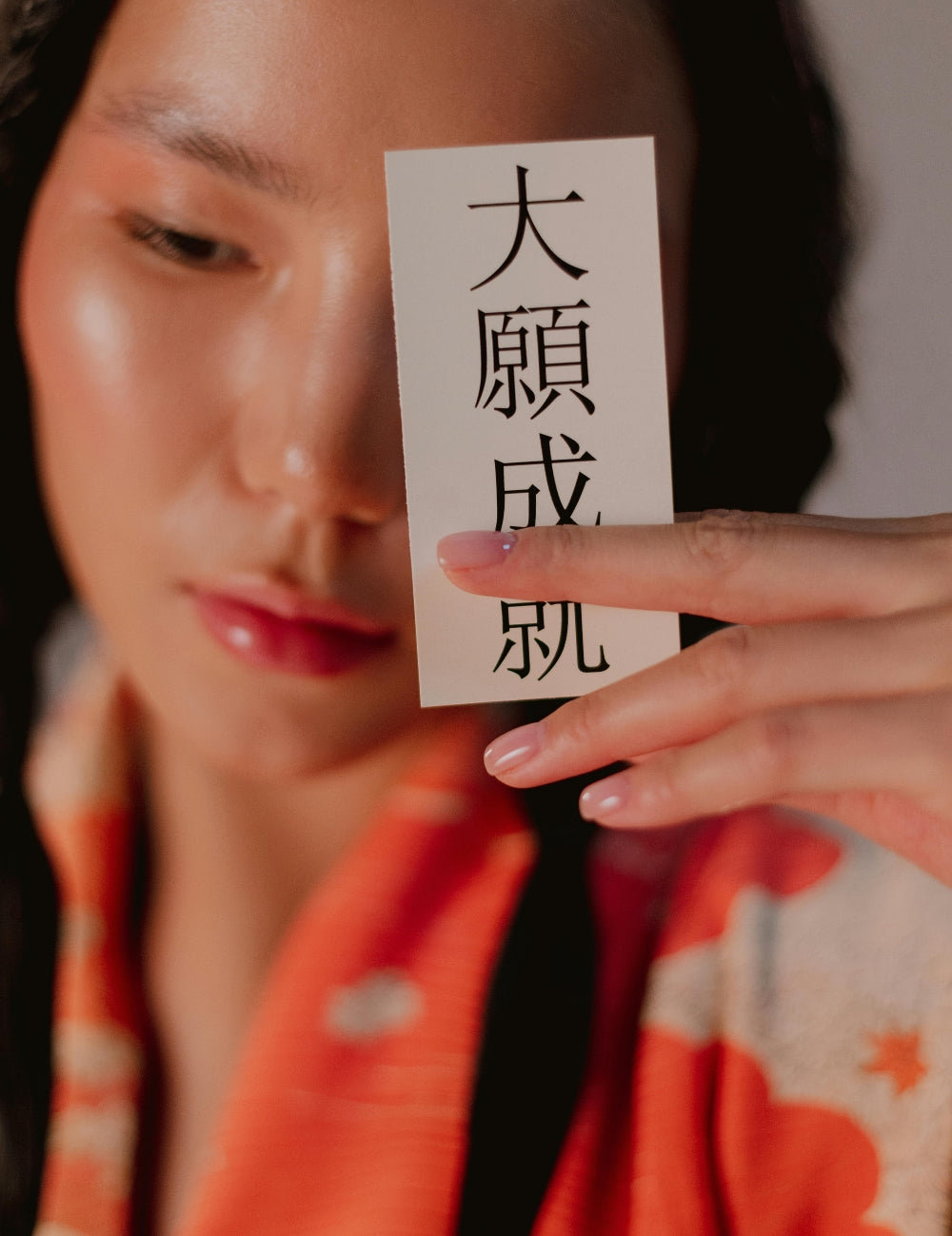 Close-up of a woman holding Japanese calligraphy paper, symbol of traditional culture — Japanstreet.