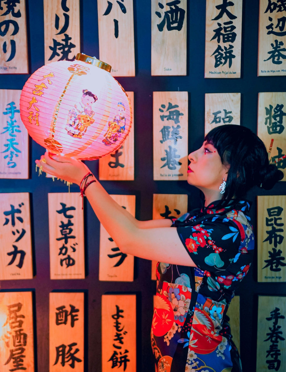 Woman holding a pink Japanese lantern in a neon-lit Tokyo atmosphere — Japanstreet Community.